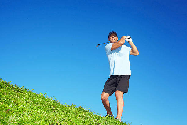 istock Golfer Swinging Golf Club On Course 525178061