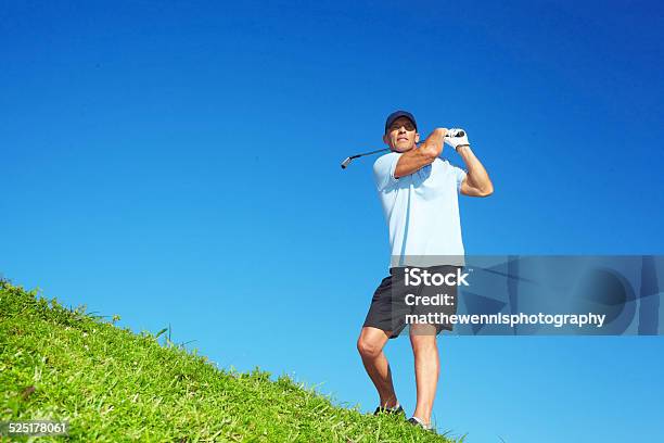 Golfer Swinging Golf Club On Course Stock Photo - Download Image Now - 40-49 Years, Activity, Adult