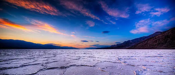 Sunset makes for great texture on the ground and color int he sky at the Badwater area of Death Valley National Park in California