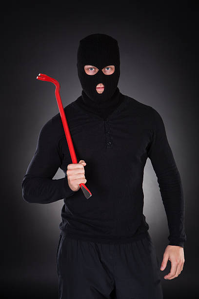 istock Masked thug or criminal with a crowbar 525180129