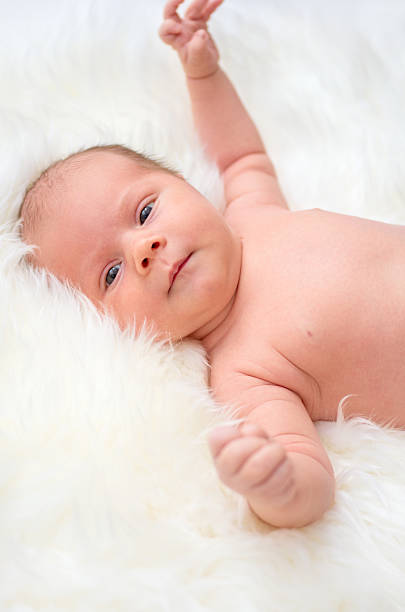 istock Baby lying on a fur bedspread 525192897