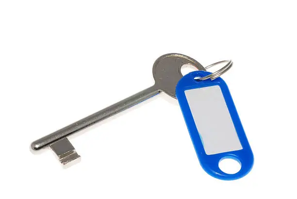 Blue plastic keyholder with key on white background