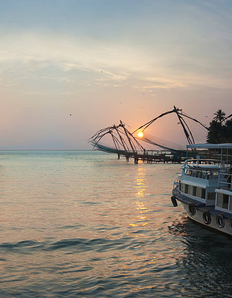Chinese Fishing Nets at Sunset Cochin's famous Chinese Fishing nets seen at sunset cochin kerala india chinese fishing net stock pictures, royalty-free photos & images