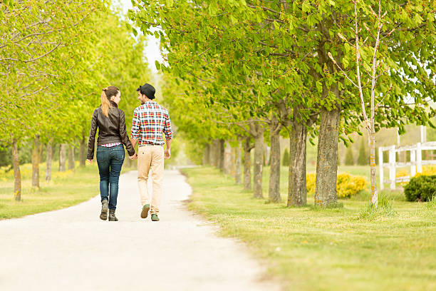 istock Young couple walking in the park 525194769