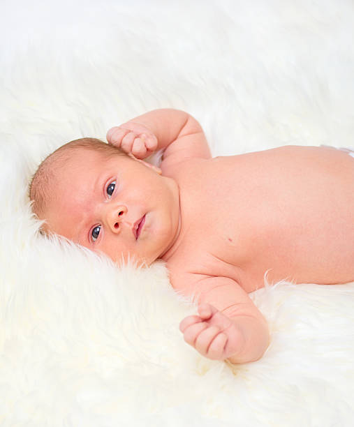 istock Baby lying on a fur bedspread 525196875