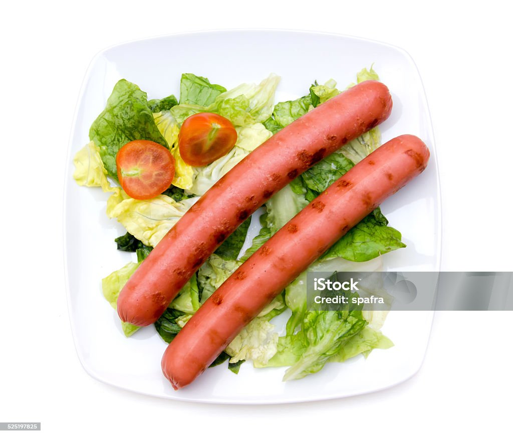 Sausages with salad from above Sausages with salad on plate on white background viewed from above Appetizer Stock Photo