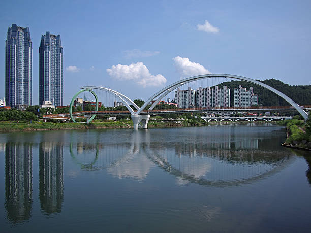 A new and modern neighbourhood with highrises and other buildings in Ulsan, South Korea during the day. The Taehwa River - also known as Taehwagang - runs through the city. 