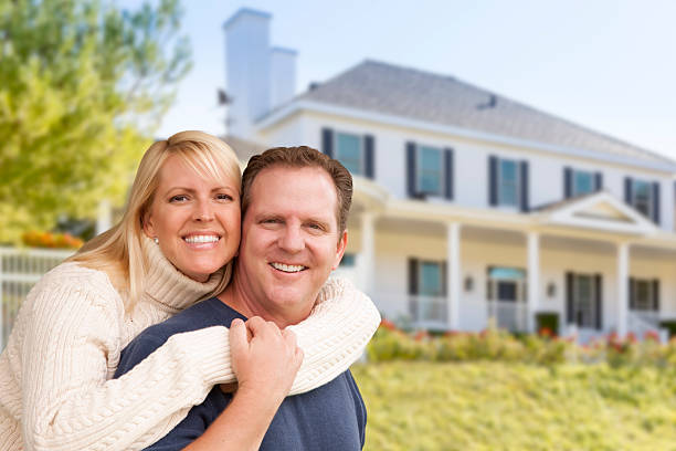 istock Happy Couple Hugging in Front of House 525199011