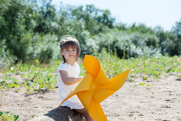 istock Smiling little girl playing with windmill 525199325