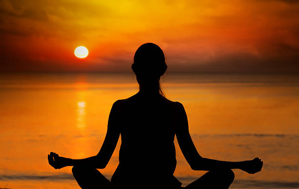 istock Woman doing Yoga at sunset 525200537
