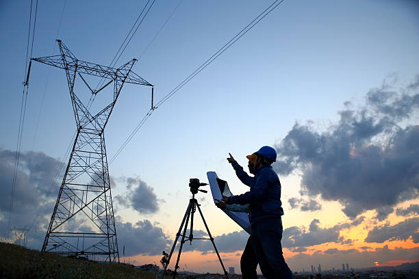 istock Silhouette of engineers workers at electricity station 525205064