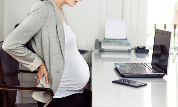 istock Pregnant woman feeling sick at work 525206528