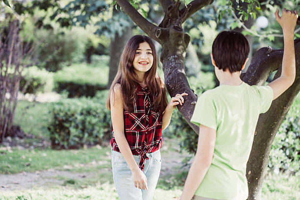 istock Boy and Girl Talking under a Tree 525208350