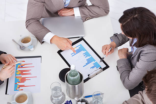 istock Business People Discussing On Graph At Conference Table 525208571