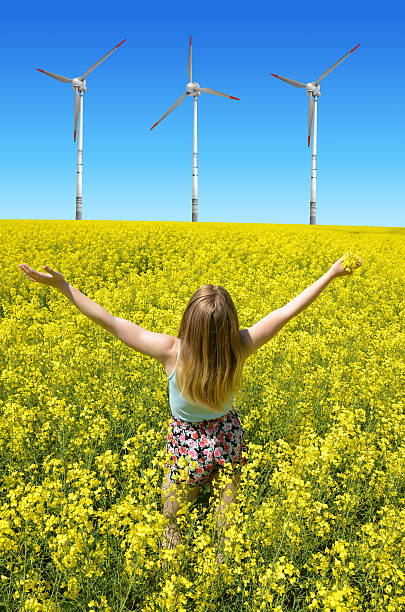 istock Young happy woman on blooming rapeseed field 525208680
