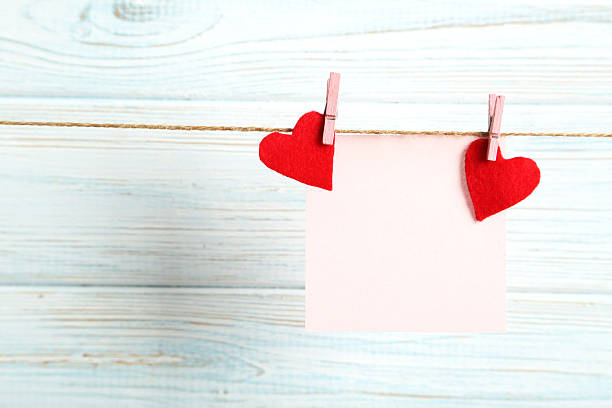 istock Blank paper hanging on rope on blue wooden background 525209874
