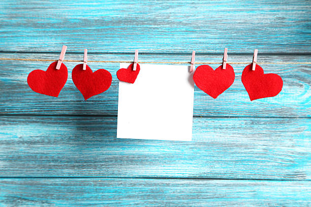 istock Blank paper hanging on rope on blue wooden background 525209984