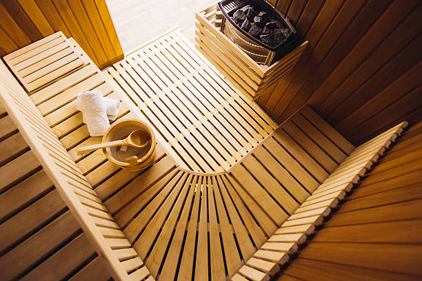 Sauna room Traditional wooden sauna for relaxation with bucket of water and set of clean towels swedish sauna stock pictures, royalty-free photos & images