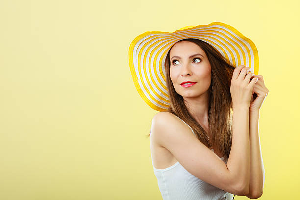 istock Woman in big yellow summer hat. 525210752