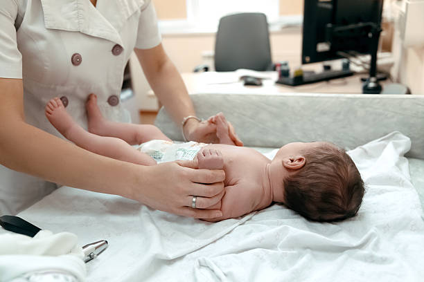 istock Pediatrician examining littlle newborn baby 525211112