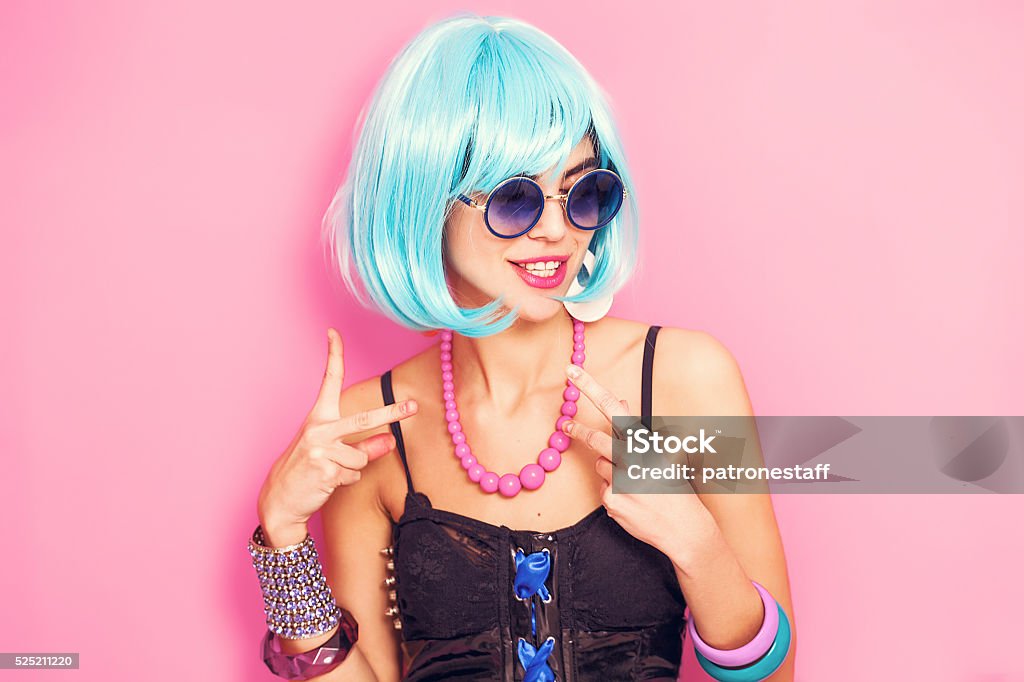 Weird and funny pop girl portrait wearing blue wig Bizarre Stock Photo