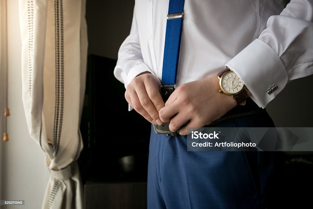Closeup of elegant man wearing suspenders Closeup photo of elegant man wearing suspenders Getting Dressed Stock Photo