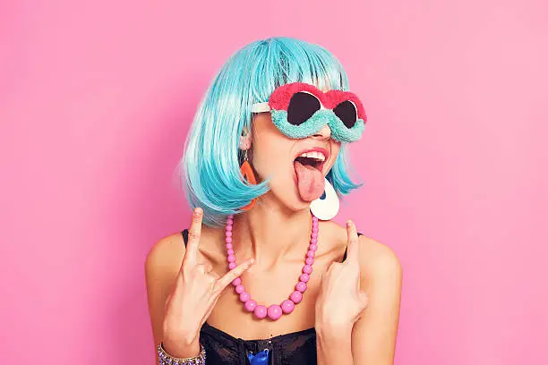Photo of Pop girl portrait wearing weird sunglasses and blue wig