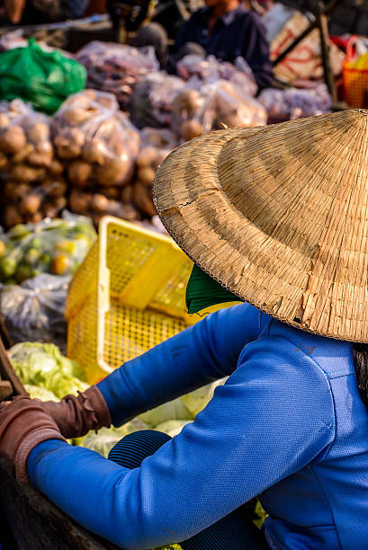 Woman vegetables seller, floating market, Mekong river, Vietnam stock photo