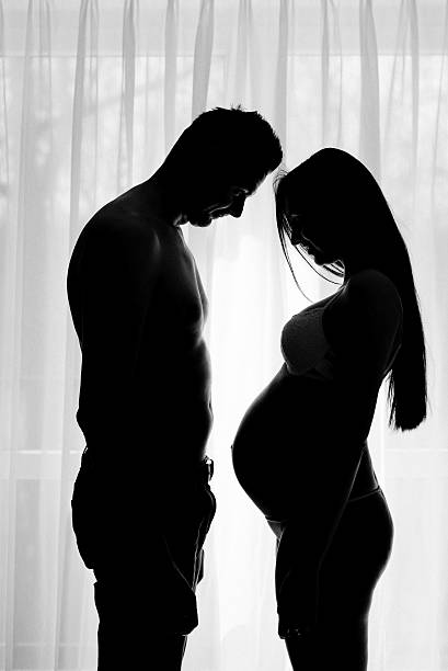 istock Silhouettes of young future parents. 525213294