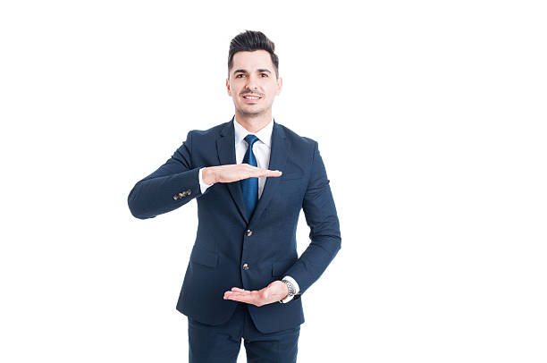 istock Smiling business man holding copy space with hands 525213314