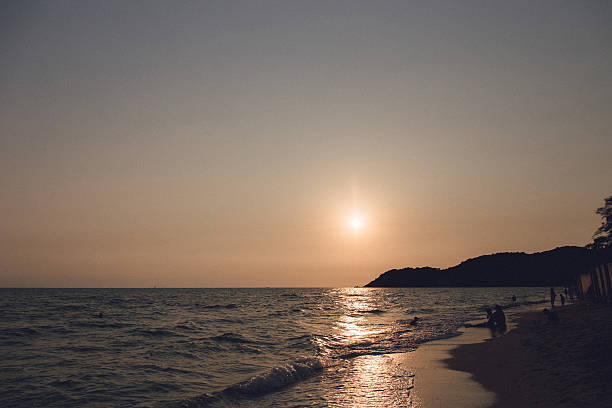 istock Silhouette  on the beach at sunset 525213854