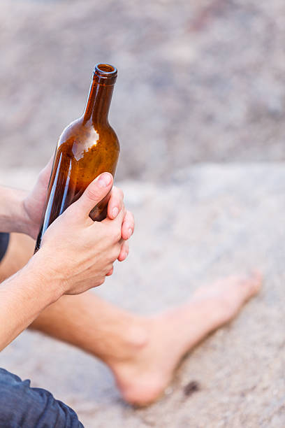 istock Male hand with wine bottle outdoor 525214892