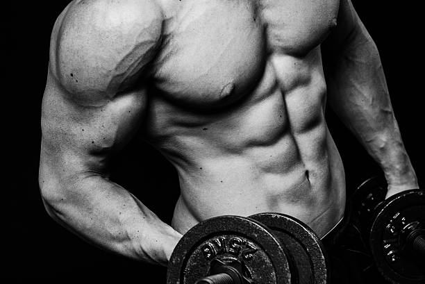 istock Close up of muscular bodybuilder guy doing exercises with weights 525216526