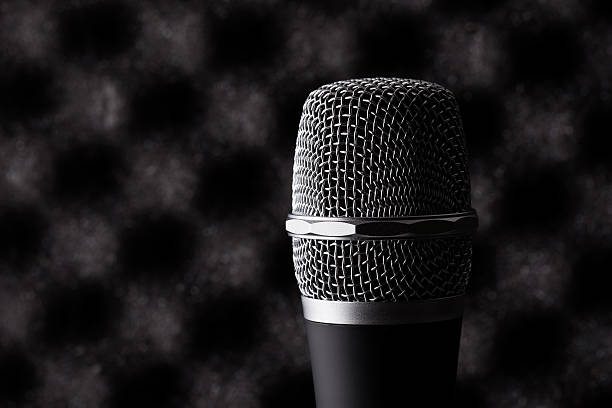istock Wireless microphone closeup on foam acoustic background 525217391