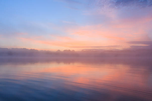 Sunrise over misty lake