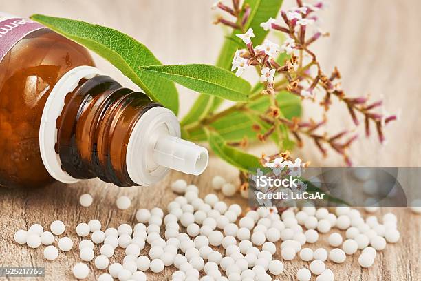 Homeopathic Granules Scattered On A Wooden Table Stock Photo - Download Image Now - Alternative Medicine, Alternative Therapy, Blue