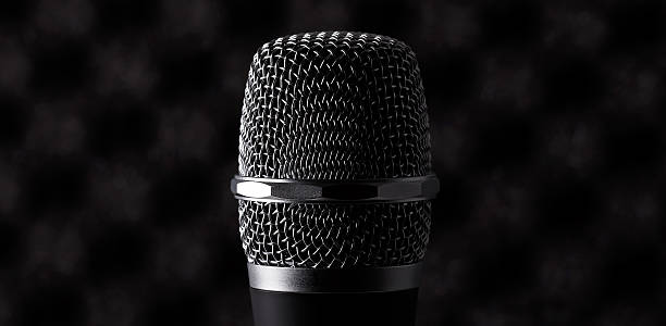 istock Wireless microphone closeup on foam acoustic background 525217797
