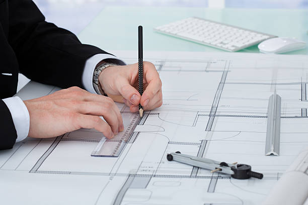 istock Businessman Working On Blueprint At Desk 525218393
