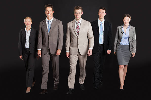 istock Confident Business People Walking Against Black Background 525218485