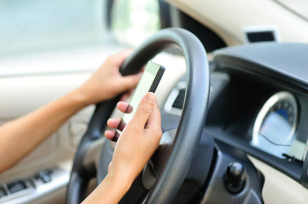 istock woman driver use her cell phone in car 525218801