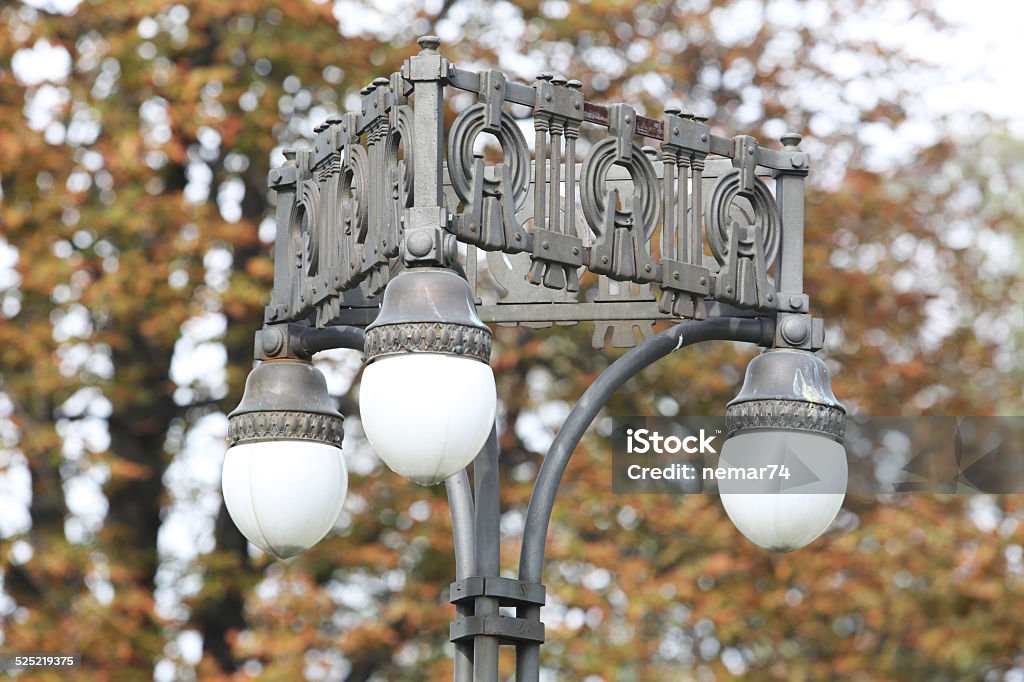 Old Street Lamp and Treetop Branches Old Street Lamp and Treetop Branches with three bulps Architecture Stock Photo