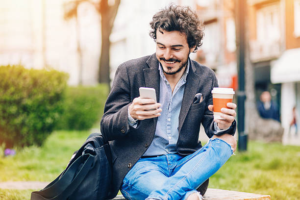 istock Man with phone and coffee outdoors 525219500