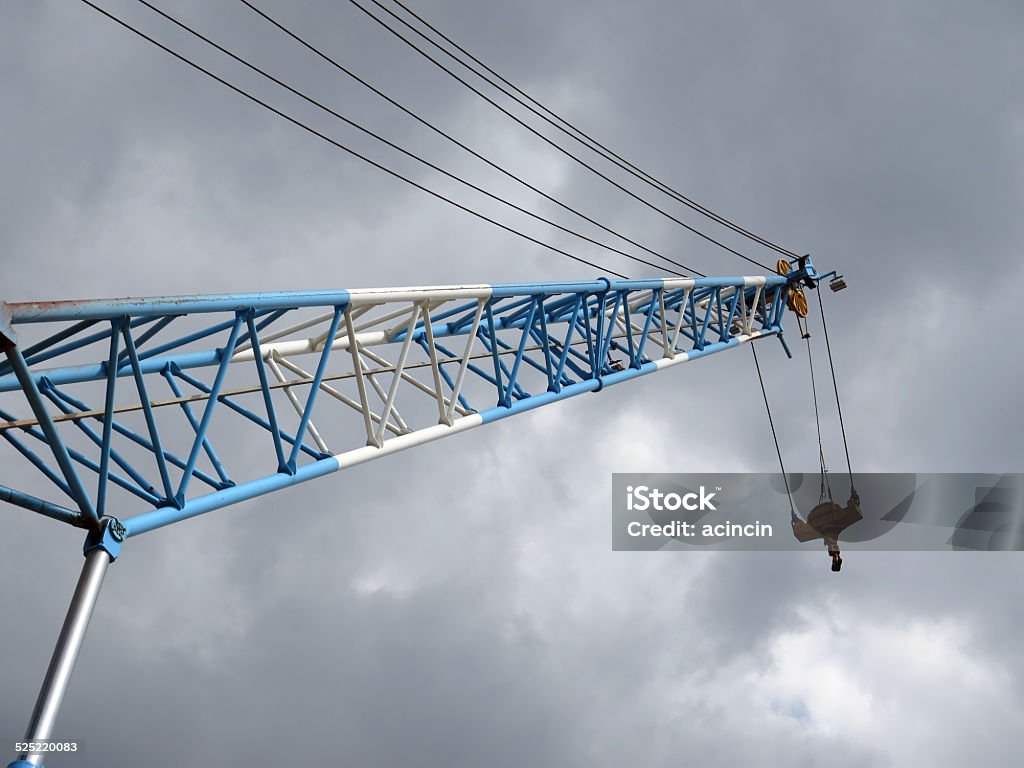 Winch Crane jib and hook with steel cable. Blue Stock Photo