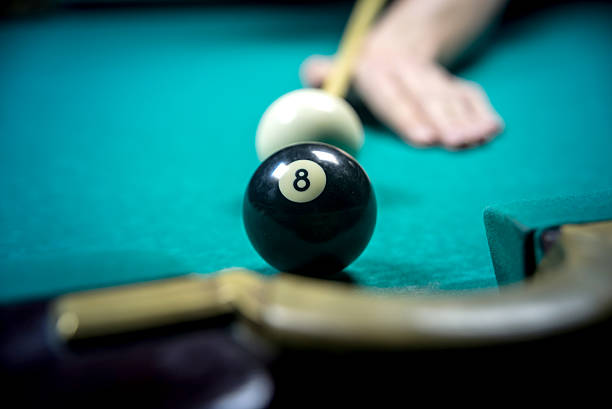 istock man playing billiards in dark club 525220530
