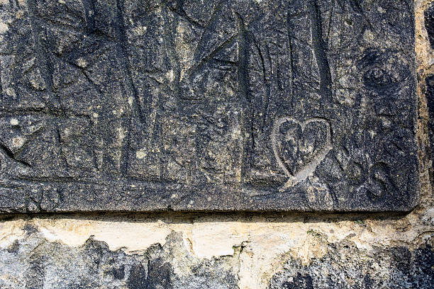 istock Old grey stone wall with heart as background 525220796