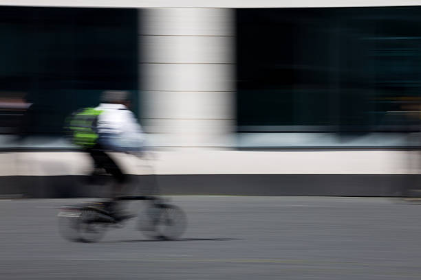 istock man on bicycle riding through the city 525220828