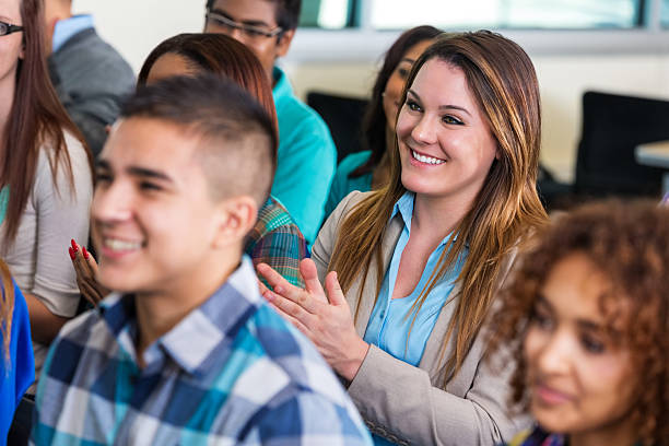 istock Young woman applauding speaker during orientation or seminar 525220843