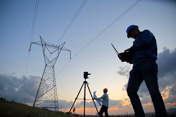 istock Silhouette of engineers workers at electricity station. 525221564