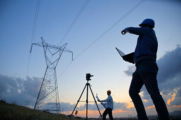 istock Silhouette of engineers workers at electricity station. 525221930
