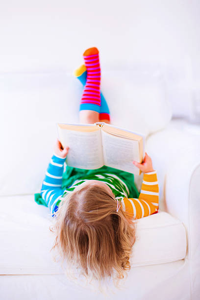 istock Little cute girl reading 525222447